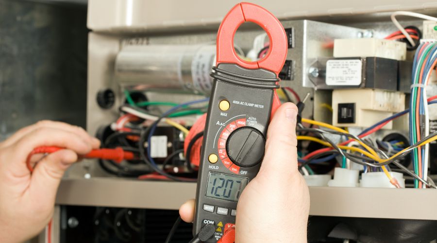 Technician using a multimeter to diagnose electrical issues in a heating system, emphasizing the importance of heater repair for home comfort and safety.